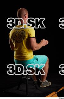 Sitting reference of whole yellow shirt turquoise shorts brown shoes…